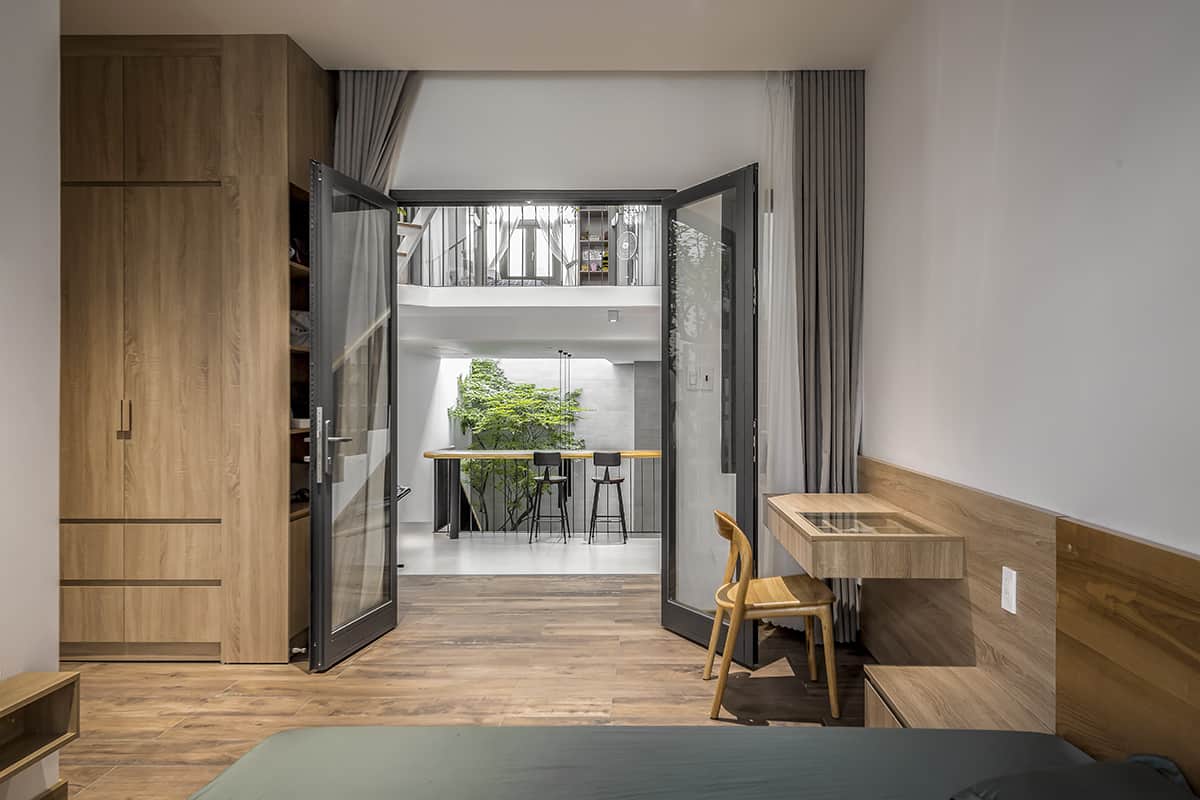 This bedroom features a french door and a built-in desk that doubles as a vanity.
