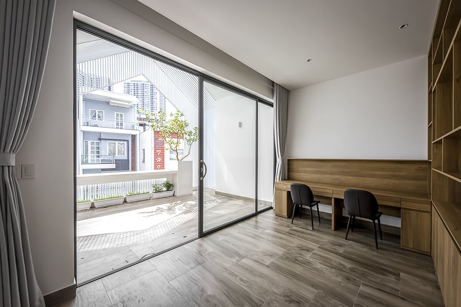 Oversized sliding glass doors lead to another balcony.