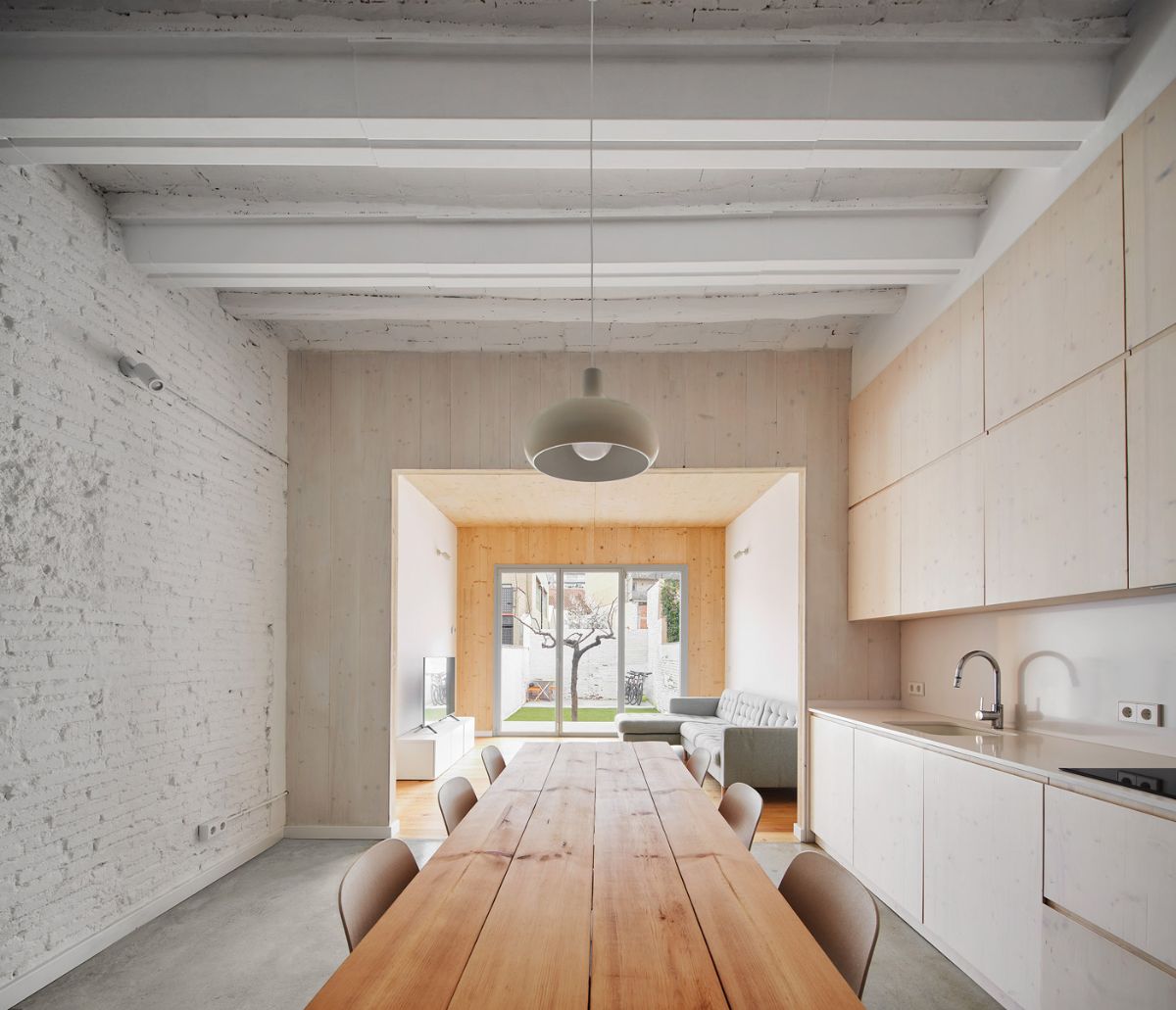 The dining room is connected to the living room, and the area shows the presence of the brick wall.