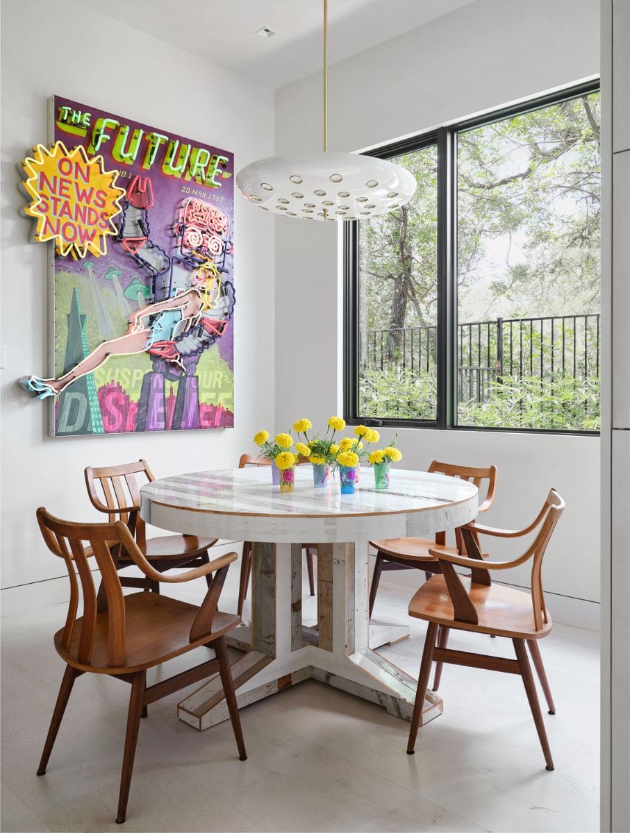 A breakfast nook with four seated round table.