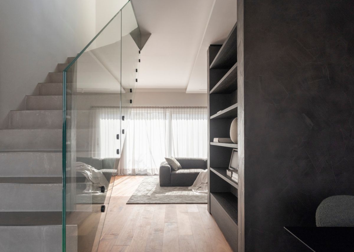 A glass railing stairwell leading up to the terrace.