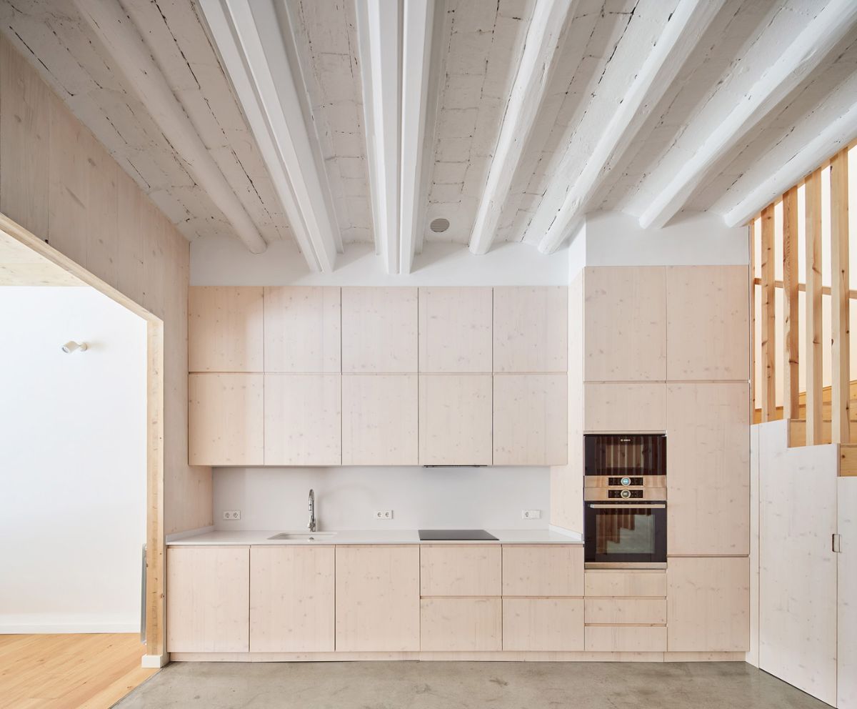 A one-wall kitchen layout with a concrete floor finish.