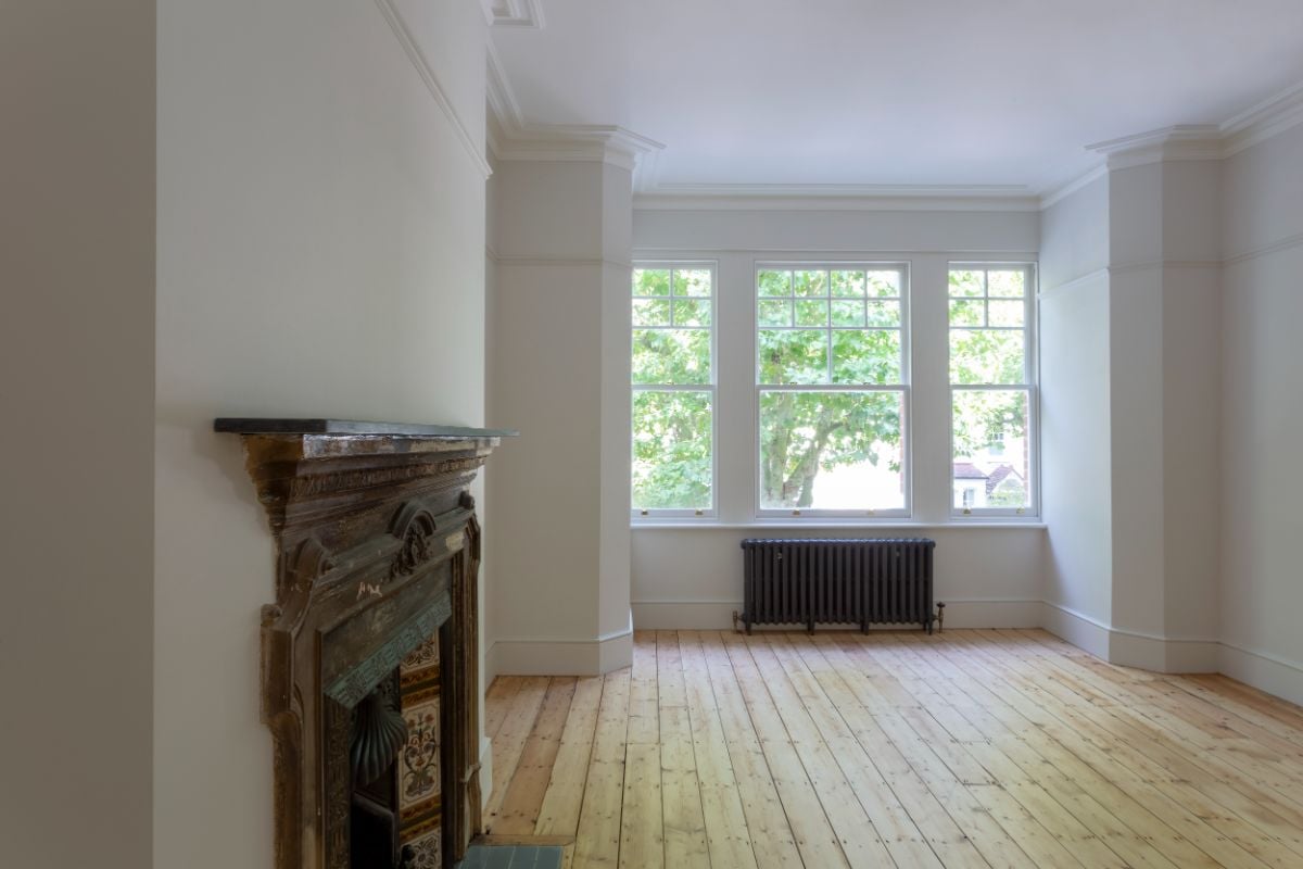 The front bedroom has an old fireplace that is still visible on the wall.