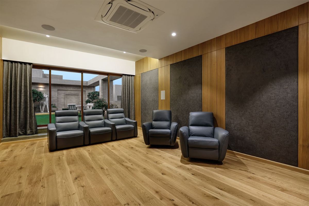 Home theatre with an arrangement of opening up to the patio garden which has multi shaded kota ground surface and tile cladding on walls.