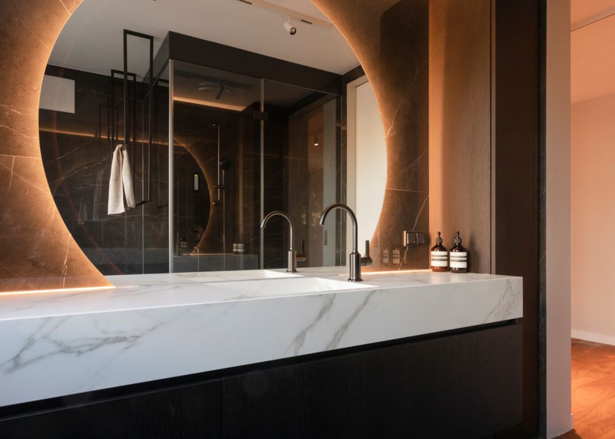 The en-suite bathroom, complete with backlit vanity mirrors.