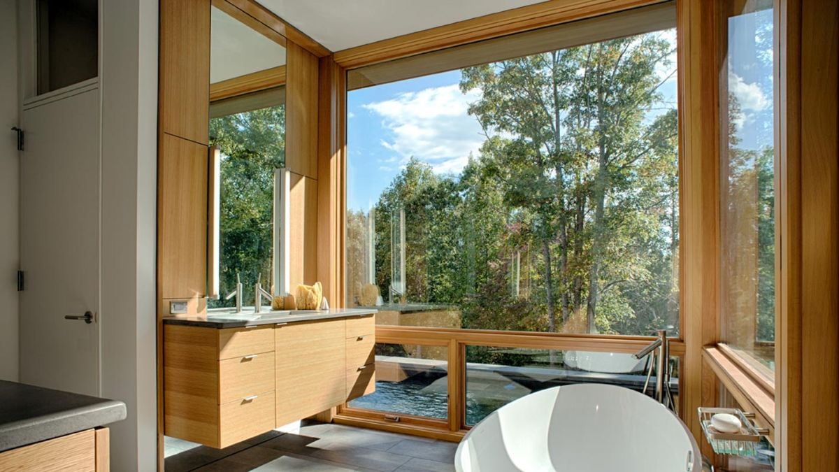 The bathroom features a floating vanity and a freestanding bathtub.