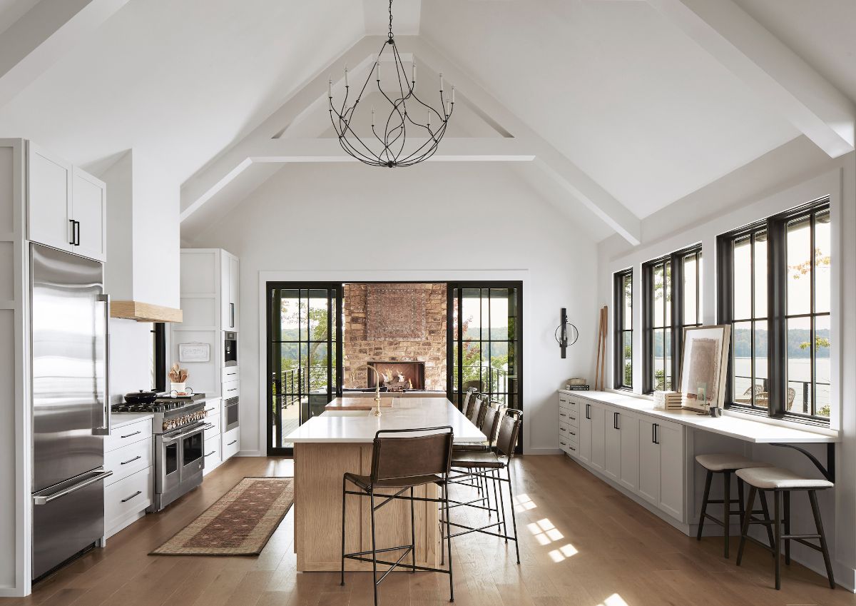 The kitchen features a bi-level kitchen island and a wood fireplace.
