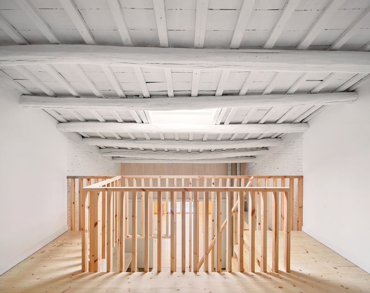 Wooden stairs lead to the new attic, created from the same type of wood.