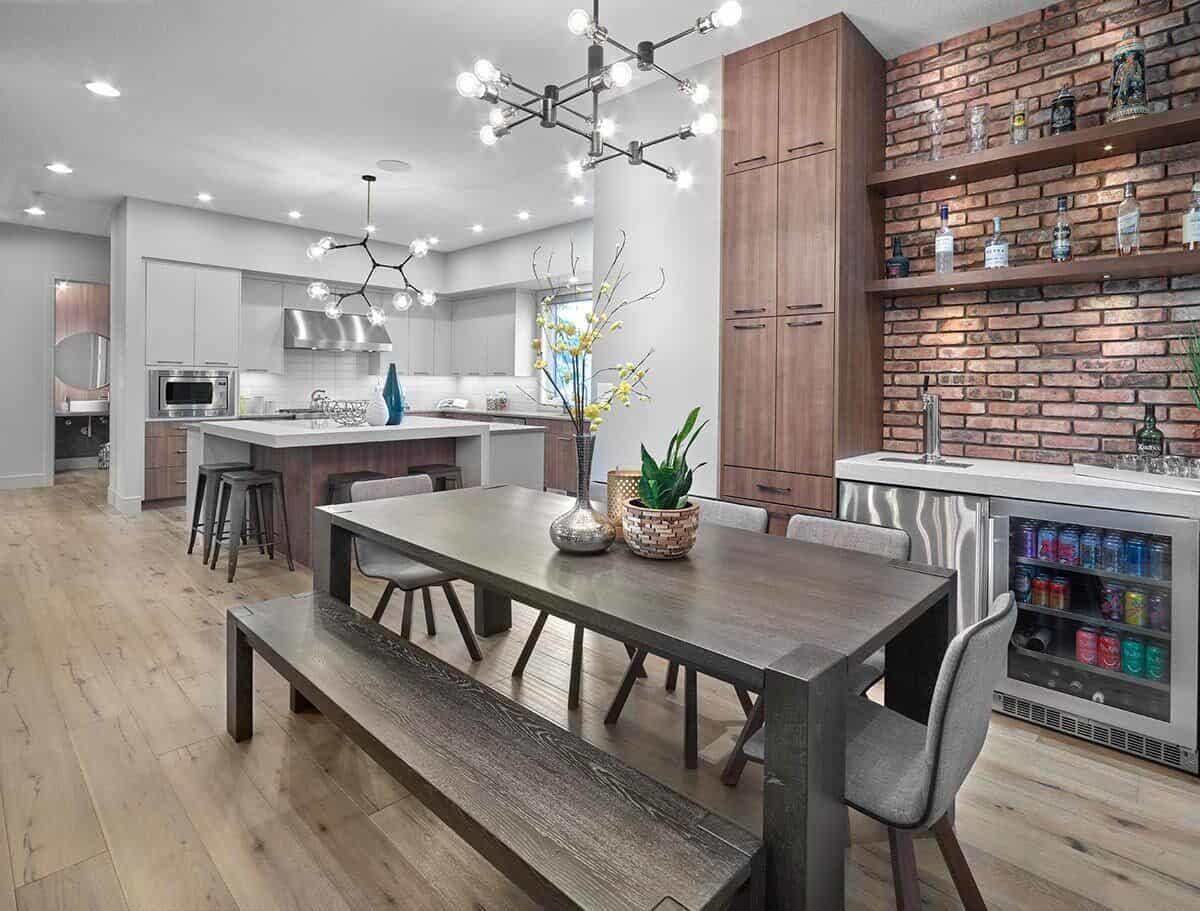 The dining area offers a rustic dining set surrounded by a matching bench and upholstered chairs.The dining area offers a rustic dining set surrounded by a matching bench and upholstered chairs.