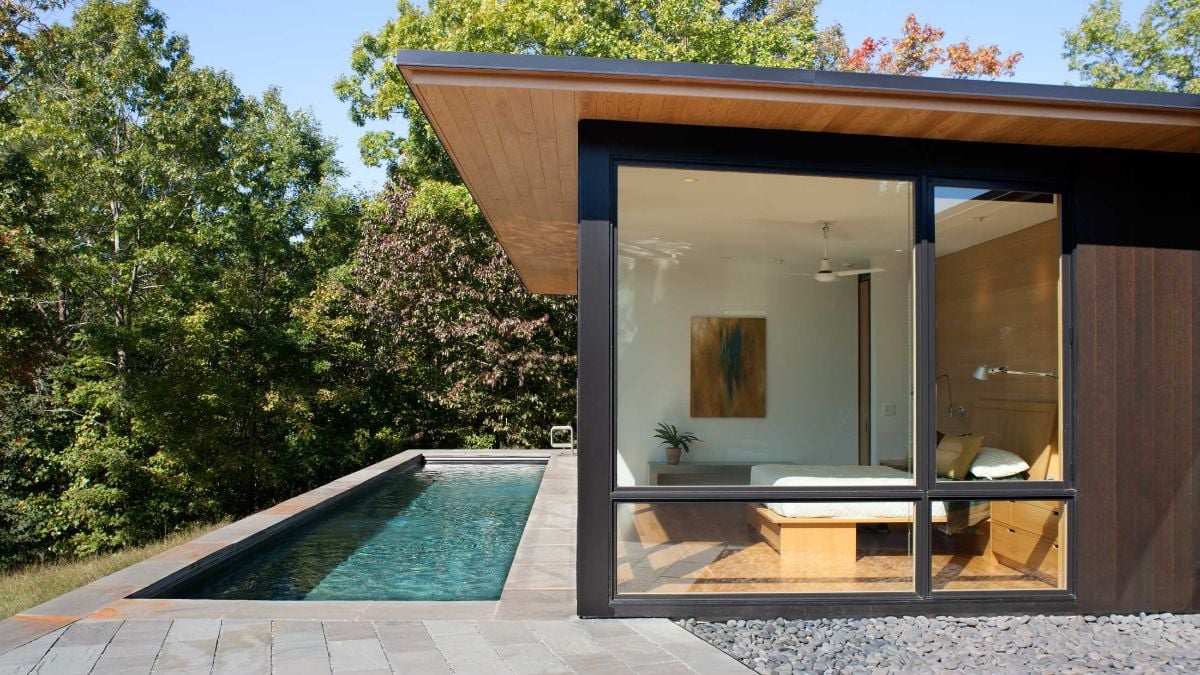 The swimming pool has the perfect spot for relaxation while watching over the surrounding trees.