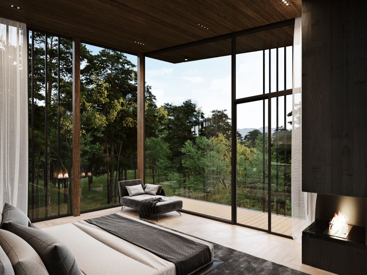 The master bedroom has large glass walls with wooden frames creating a rustic and cozy atmosphere.