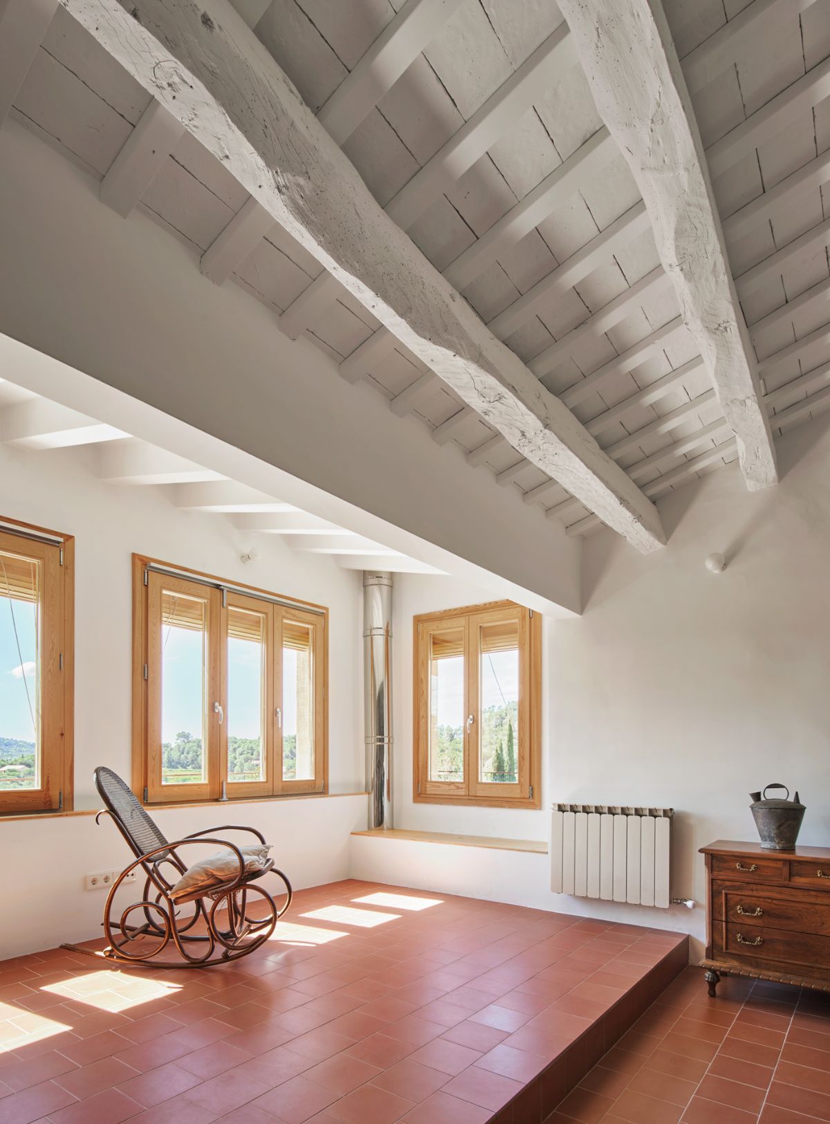The house has a balcony that oversees the landscape outside.