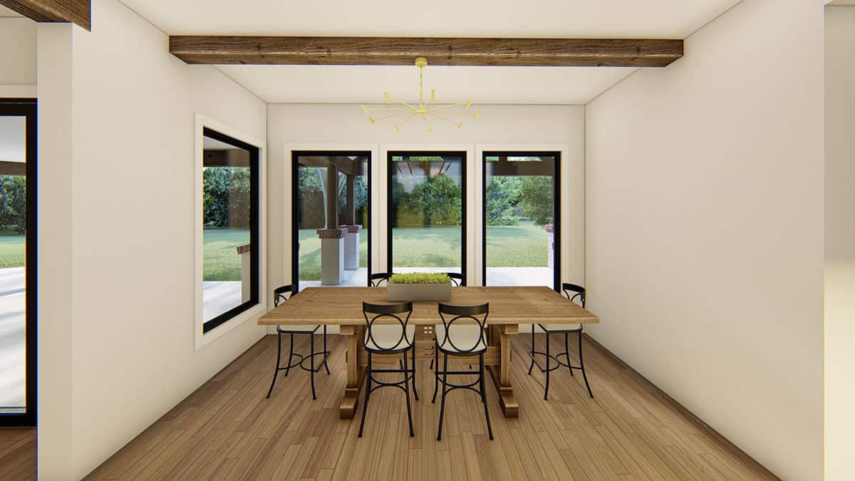 Dining room with a wooden dining set and great views of the covered porch and backyard.