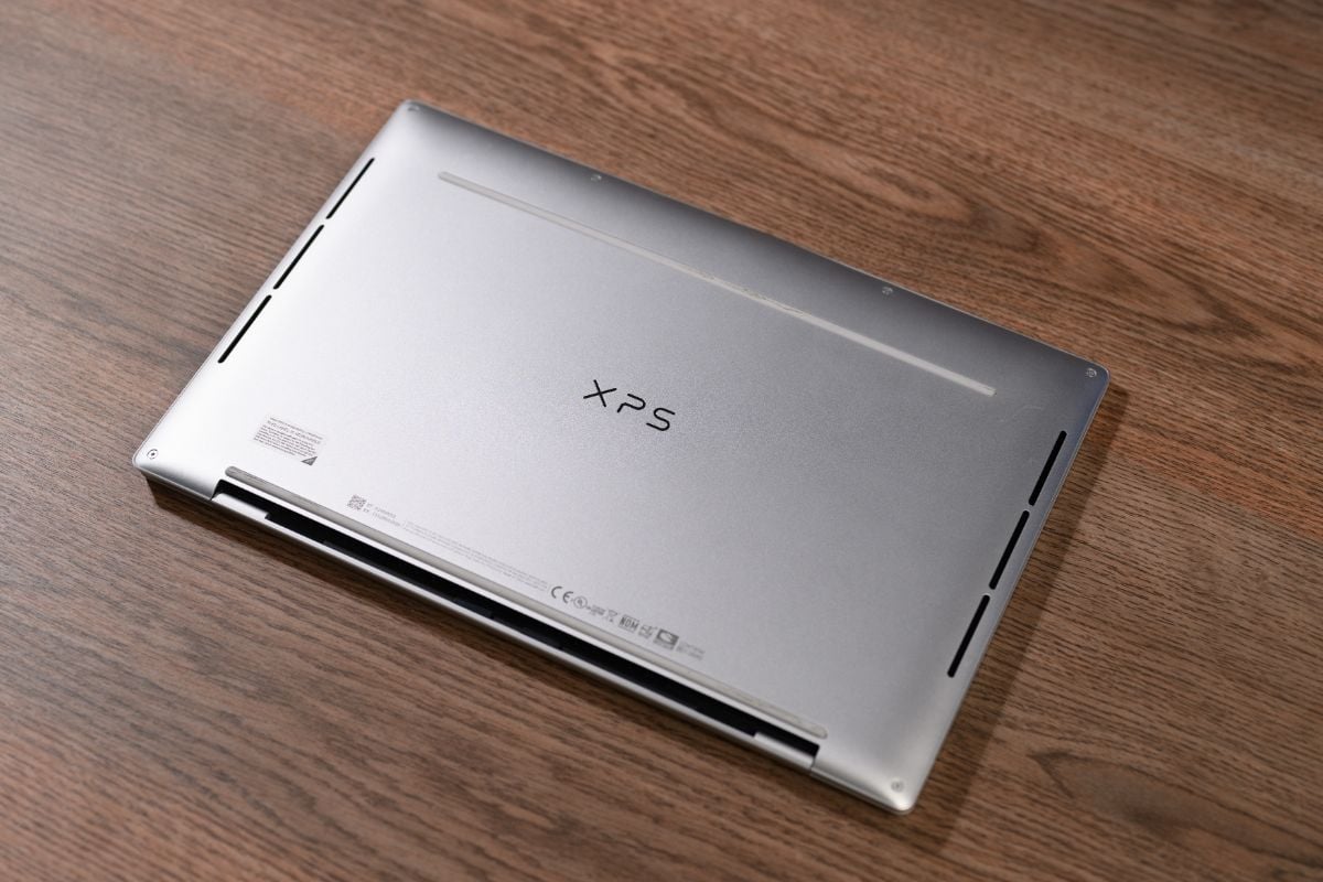 Dell XPS 13 on a wooden background.