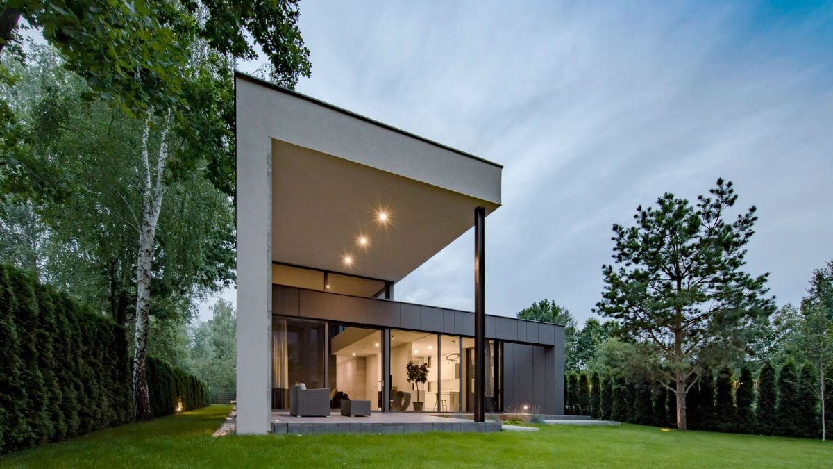 This is an exterior photograph that highlights the expansive glass walls on the lower level of the building, as well as the high ceiling, which contribute to the distinctiveness of the architectural design.