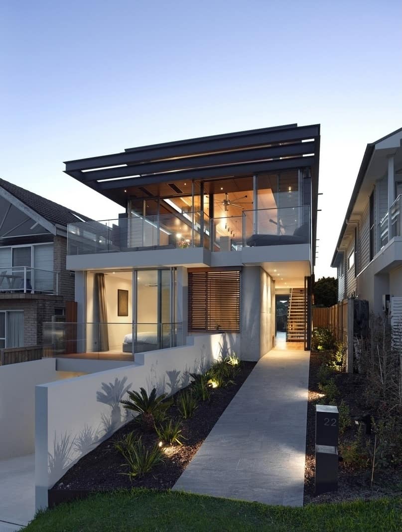 A concrete walkway leads to the home's entry.