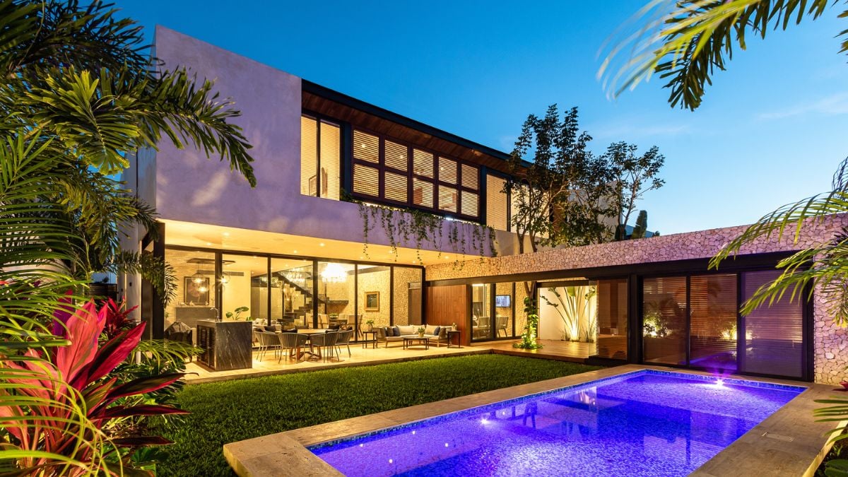 The photograph captures the essence of the house's idyllic outdoor lifestyle, with the pool area serving as the ultimate embodiment of relaxation and leisure.