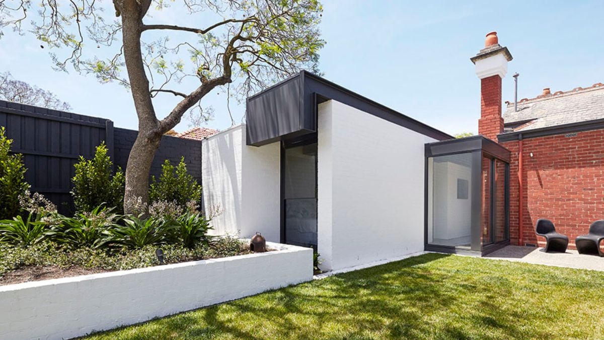 The photo displays an exterior view of the section that links the old and new parts of the house.