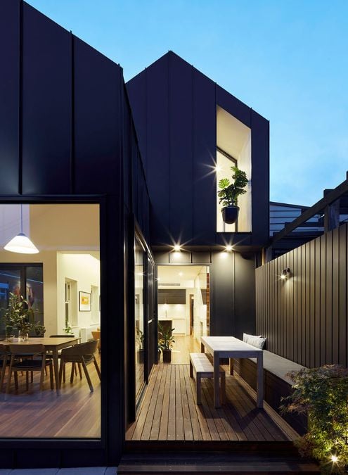 This photograph captures the outdoor space of the house in a nighttime setting, highlighting its harmonious integration with the indoor areas.