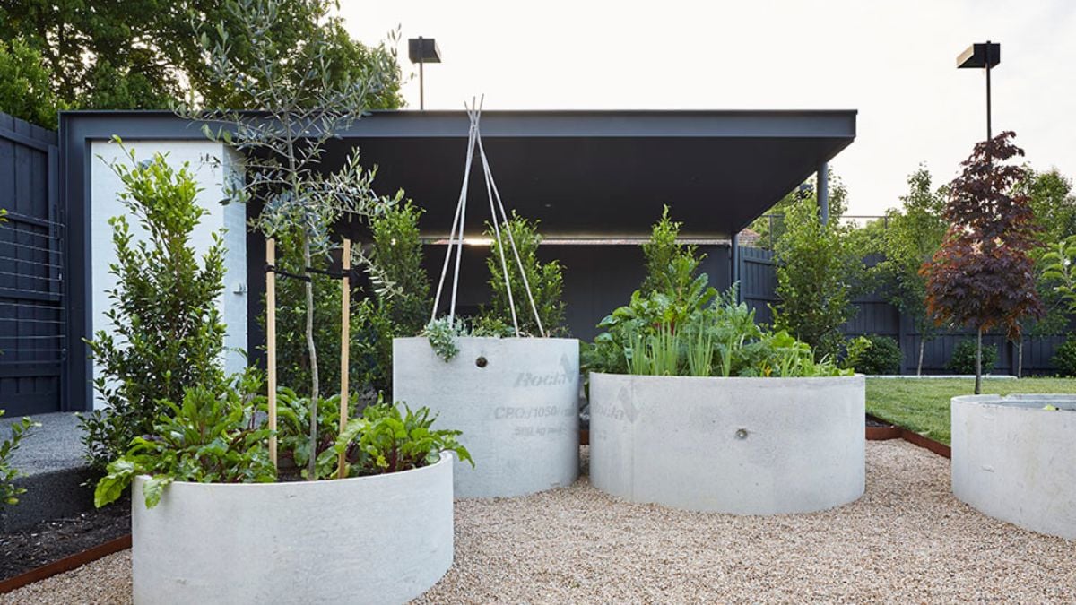 The outdoor garden features three circular planter rings, providing space to grow a variety of plants.