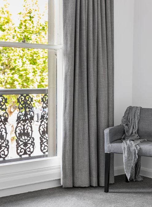 The visual content provides a partial glimpse of the upper-level bedroom within the house, emphasizing a window that offers a limited yet noteworthy perspective of the surrounding outdoor view.