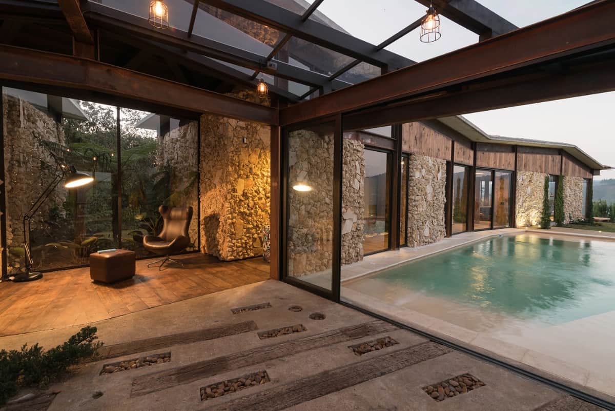 A broad corridor topped by skylights connects the central area to the pool deck.