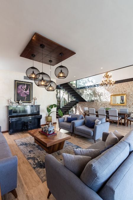 The image showcases the interior design of the house's living area, highlighting the elegant furnishings, art, and decor that contribute to its overall ambiance.