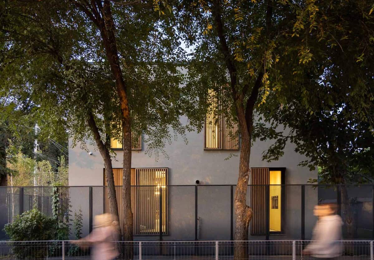 At night, warm glow peeks from the shuttered windows.