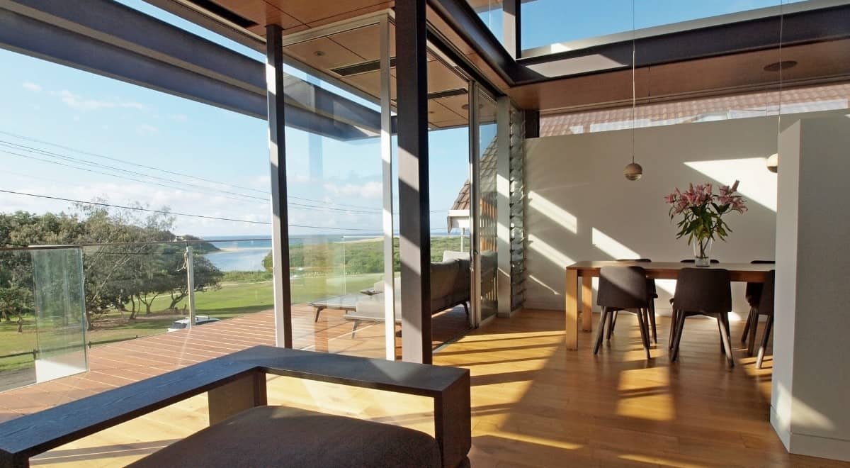 Sliding glass doors extend the living area onto an open deck.