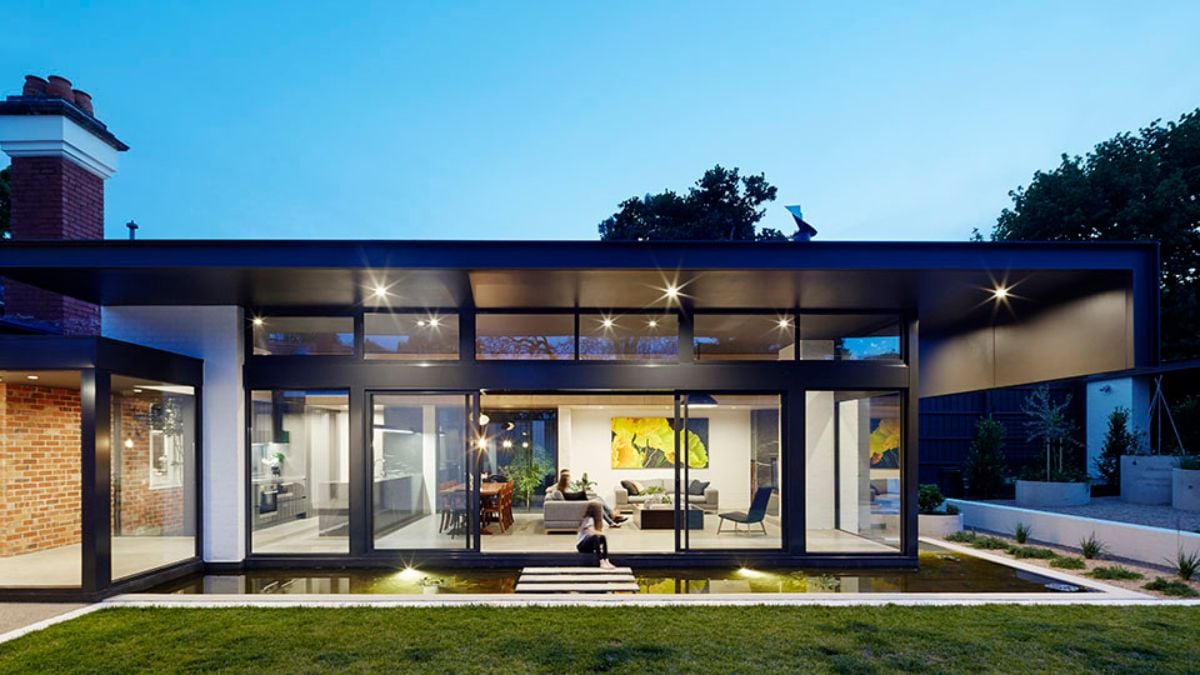 The photo showcases a detailed view of the modern building, with wide glass panels offering a clear view of the spacious interior.