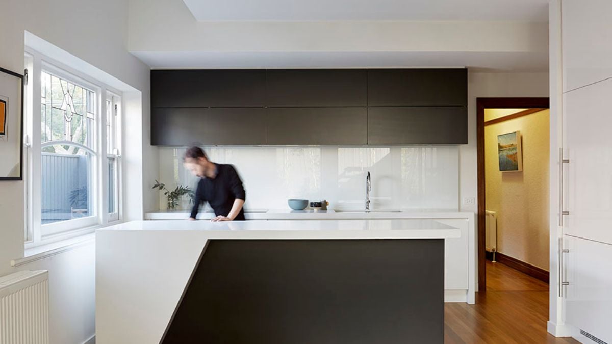 This photograph offers a perspective view of the kitchen, highlighting its black and white theme color design.