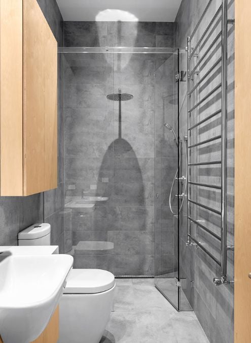 This photograph captures the interior design of the bathroom, with a focus on the shower area.
