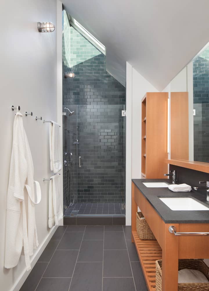 This bathroom offers a dual sink vanity and a walk-in shower crowned with a skylight.