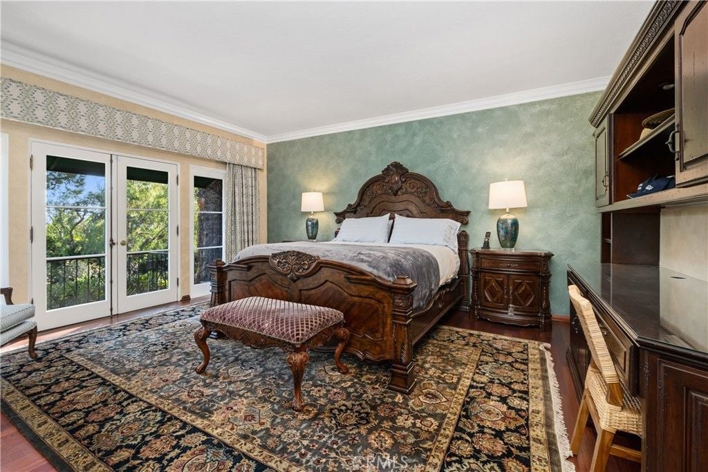 The bedroom features a wooden queen-size bed and nightstand that gives the room a luxurious feel.
