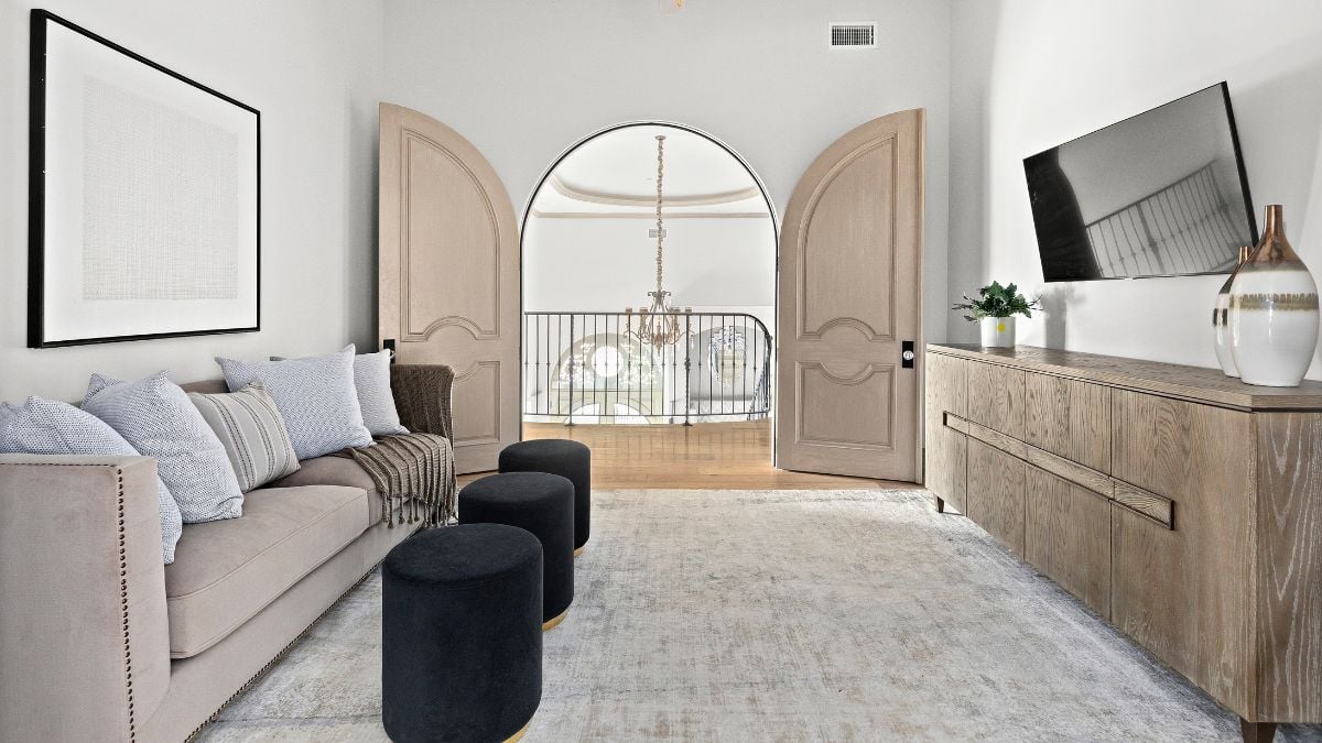 The sofa set and lovely double doors that lead into the room make this area of the bedroom even more stunning.