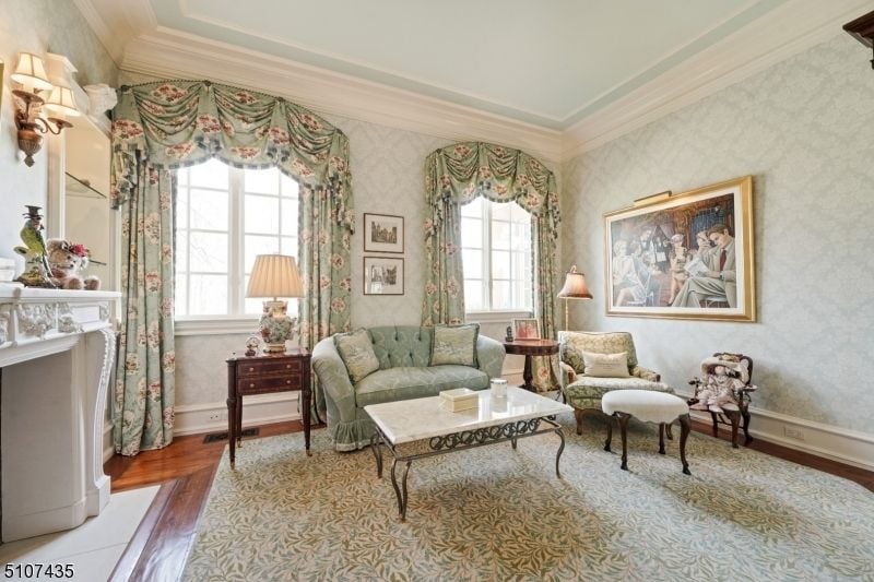 The bedroom features a small sofa and a coffee table.