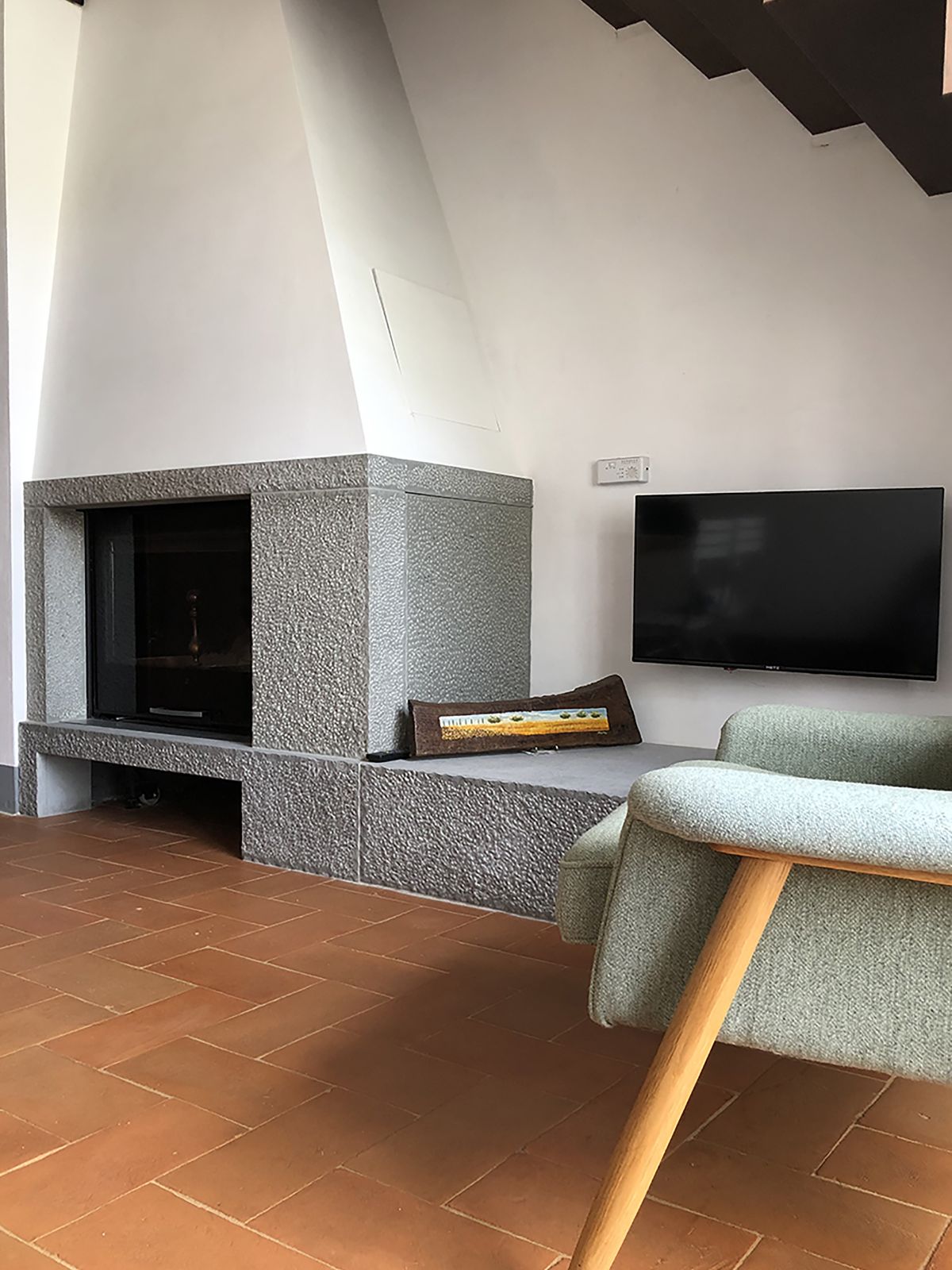 The house features a fireplace with a seat perfect for relaxation.