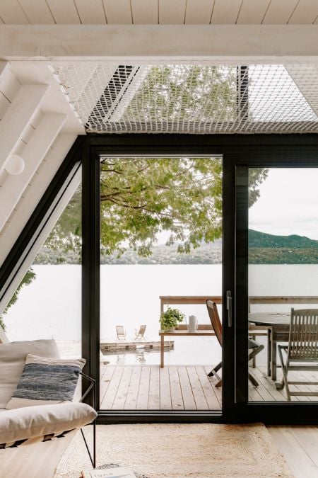 A photograph showcasing a section of the residing space with a focal point on the central sliding glass door of the dwelling.
