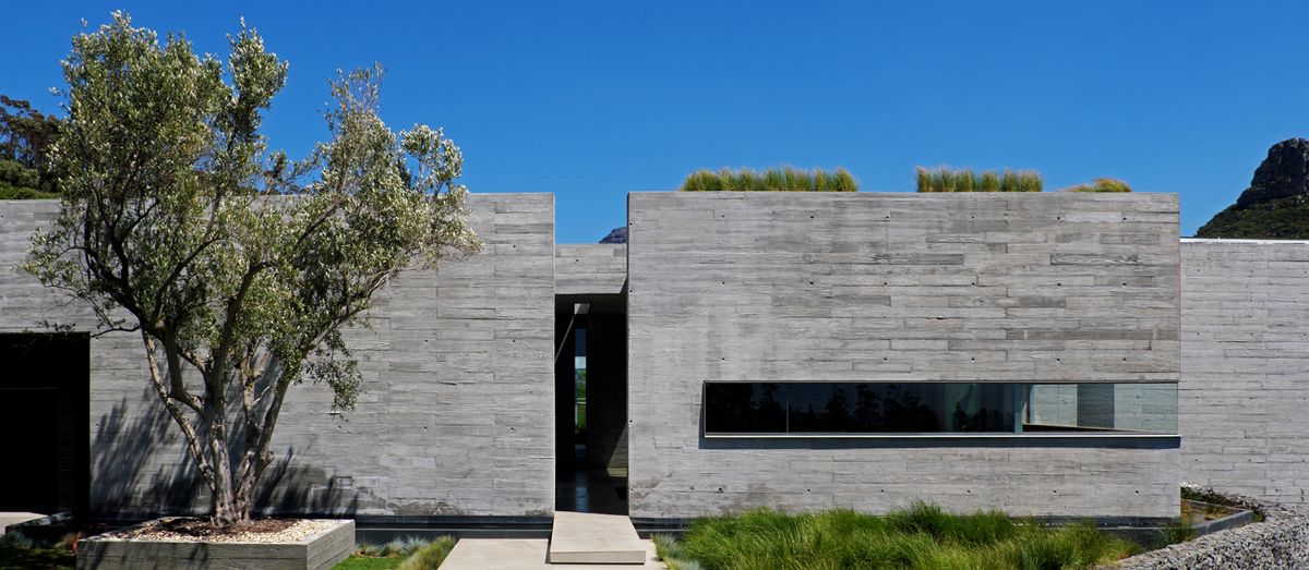 The house's off-shutter concrete block structure.