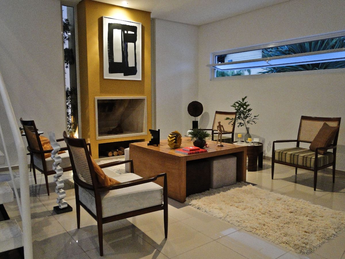 The house features a wood fireplace and an area rug giving the room a cozy atmosphere.
