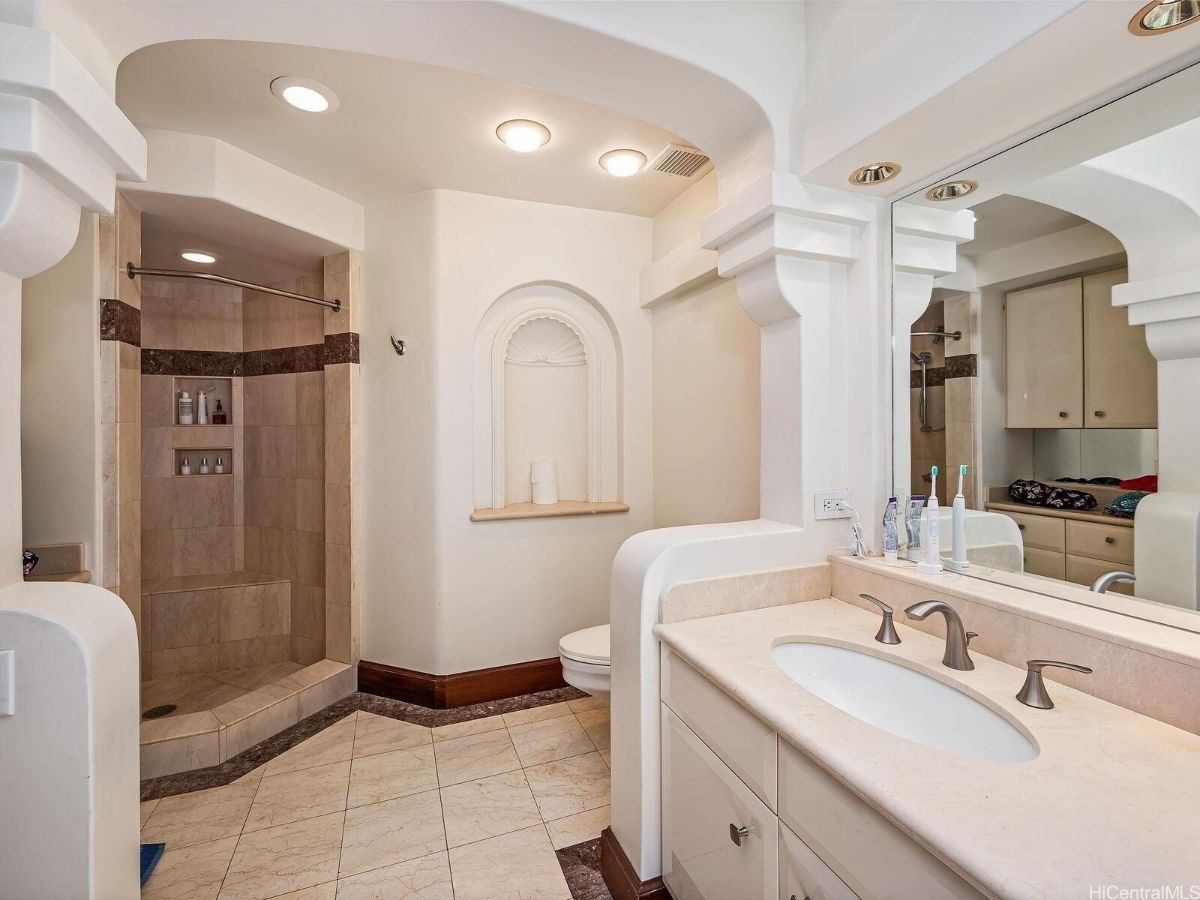 The bathroom features a shower cubicle with tile walls.