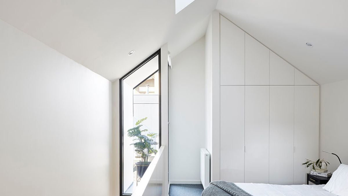 The provided image presents a different perspective of the bedroom, showcasing its highly distinctive gabled roof.