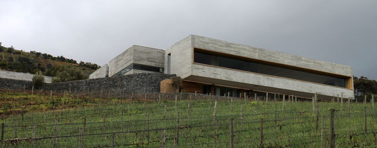 The off shutter concrete block is perforated to allow light to enter from the surrounding mountain landscape and sky.