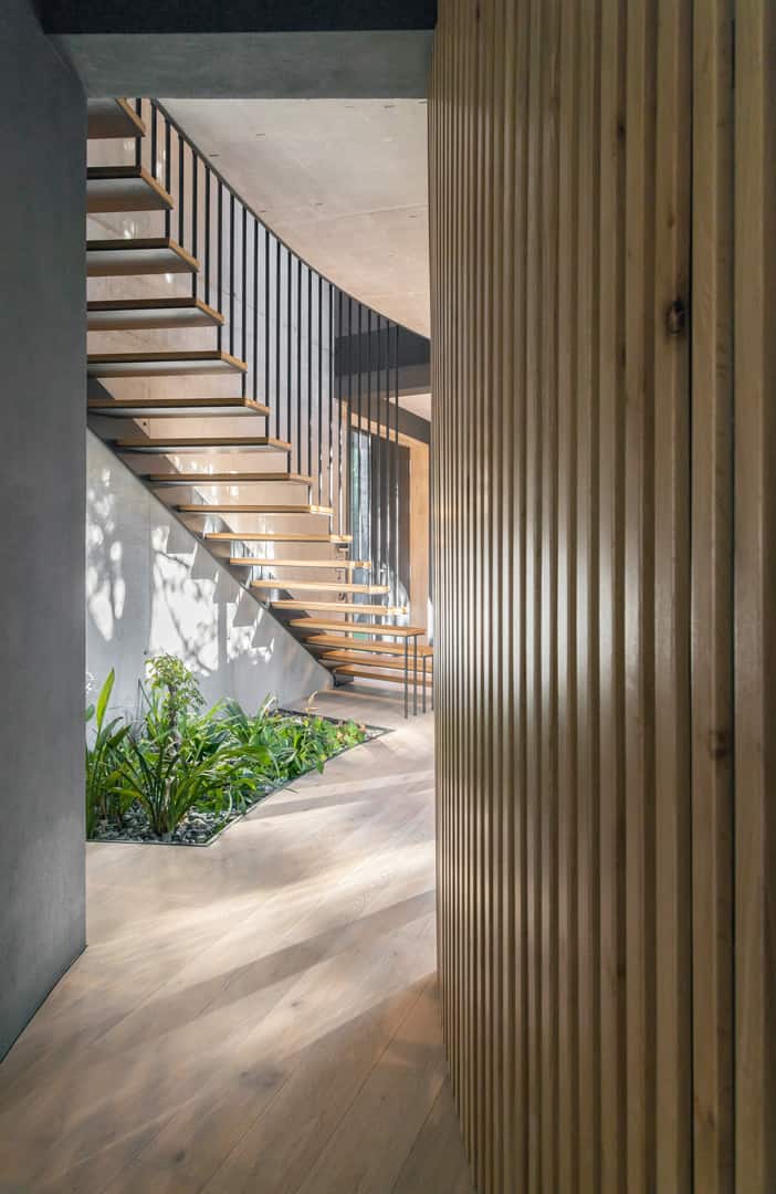 On the other side, you'll find a modern staircase with no stringer and open railings.