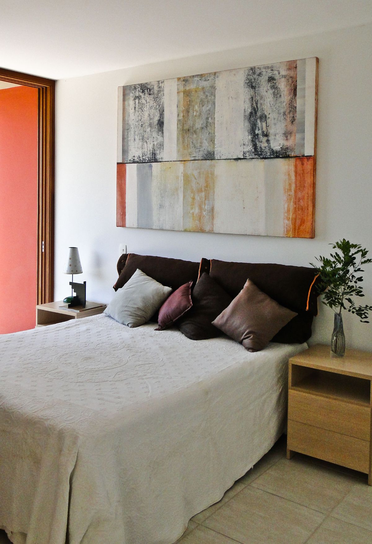 The master bedroom features nightstands and artwork.