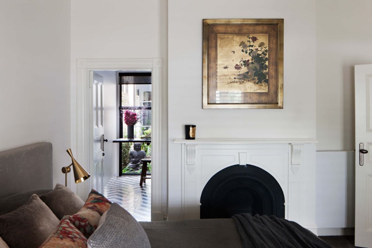 The bedroom features a queen-size bed and a fireplace that warms the place.