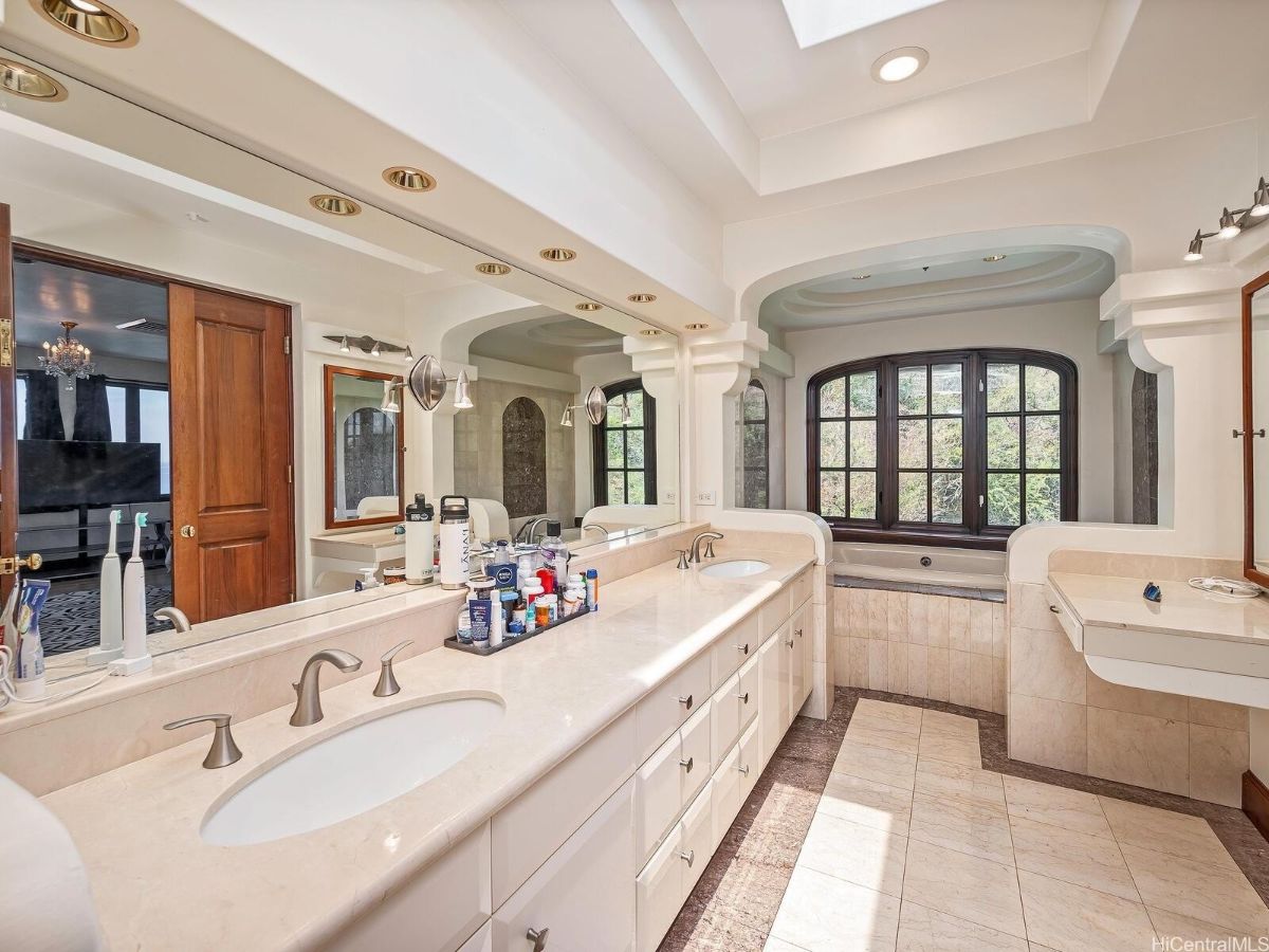 The bathroom features a vanity with a tile countertop and cabinet drawer.