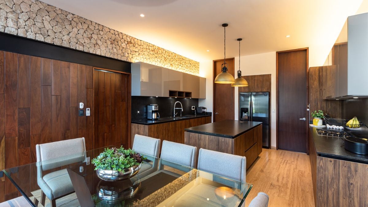 This photograph presents an interior view of the kitchen area, featuring a cozy dining set that complements the overall design of the space.
