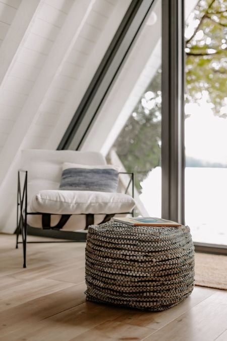 A picture capturing a segment of the living area, highlighting the foldable camping chair and the round ottoman seat.