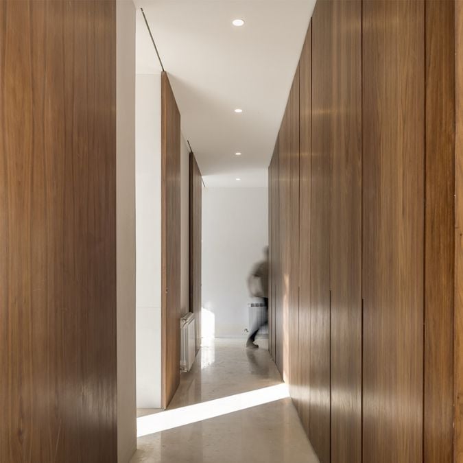 The interior shot captures a hallway that serves as a passageway to various areas of the house, providing a clear view of its design and features.